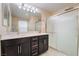 Bathroom features a double sink vanity with modern fixtures and a shower with a glass door at 2422 Fasano St, Henderson, NV 89044