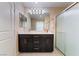 Bathroom features a double sink vanity with modern fixtures and a shower with a glass door at 2422 Fasano St, Henderson, NV 89044