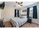 Bedroom featuring a comfortable bed and dark blue curtains providing shade and style at 2422 Fasano St, Henderson, NV 89044