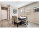 Bright dining area with a modern table, neutral decor, and wood-look flooring at 2422 Fasano St, Henderson, NV 89044