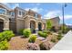 Inviting front yard with desert landscaping, a brick walkway, and covered porch at 2422 Fasano St, Henderson, NV 89044