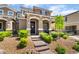 Inviting two-story home with desert landscaping, a brick walkway, and a covered front porch at 2422 Fasano St, Henderson, NV 89044