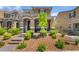 Inviting front yard with desert landscaping, a brick walkway, and covered porch with seating at 2422 Fasano St, Henderson, NV 89044
