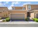 Two-story home featuring an attached two-car garage, desert landscaping, and a tile roof at 2422 Fasano St, Henderson, NV 89044