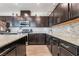Contemporary kitchen with granite countertops, stainless steel appliances and ample cabinet space at 2422 Fasano St, Henderson, NV 89044