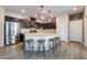 Modern kitchen with stainless steel appliances, granite countertops, and a breakfast bar with seating at 2422 Fasano St, Henderson, NV 89044