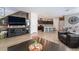 Open floor plan featuring a living room, kitchen, and dining area with wood-look floors at 2422 Fasano St, Henderson, NV 89044
