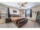 Bedroom with neutral tones, a ceiling fan, and a large window for natural light at 2422 Fasano St, Henderson, NV 89044