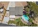 Aerial view of a property showing roof, pool, car, storage shed, and yard in a residential neighborhood at 2447 Tournament St, Las Vegas, NV 89142