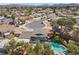 Aerial view of a residential neighborhood with a home featuring a pool and well-maintained backyard at 2447 Tournament St, Las Vegas, NV 89142