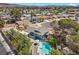 Aerial shot of a single-Gathering home featuring a backyard pool and patio area in a residential neighborhood at 2447 Tournament St, Las Vegas, NV 89142