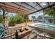 Inviting backyard oasis with pool, pergola, and stone firepit, perfect for outdoor living at 2447 Tournament St, Las Vegas, NV 89142