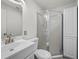 Bathroom featuring a clean white vanity, toilet, and a corner shower with a sliding glass door at 2447 Tournament St, Las Vegas, NV 89142