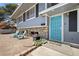 Home exterior showcasing stone accents, a vibrant blue door, and a charming landscaped area at 2447 Tournament St, Las Vegas, NV 89142