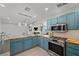 Kitchen featuring butcher block countertops, stainless steel appliances, and blue cabinets with a view into living room at 2447 Tournament St, Las Vegas, NV 89142