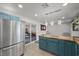 Bright kitchen with butcher block countertops, stainless steel appliances, and blue cabinets with a sliding glass door at 2447 Tournament St, Las Vegas, NV 89142