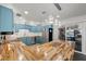 Open concept kitchen with blue cabinets, butcher block island, and stainless steel appliances at 2447 Tournament St, Las Vegas, NV 89142