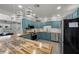 Kitchen featuring butcher block countertops, stainless steel appliances, and blue cabinets and light fixtures at 2447 Tournament St, Las Vegas, NV 89142