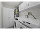 Bright laundry room with white cabinetry and modern Samsung washer and dryer set at 2447 Tournament St, Las Vegas, NV 89142