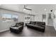 Bright living room featuring modern ceiling fan, large windows, and a comfortable seating area at 2447 Tournament St, Las Vegas, NV 89142