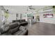 Open living room with dark wood floors, modern lighting, and stylish decor at 2447 Tournament St, Las Vegas, NV 89142