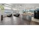 Open concept living room with eat in kitchen, with blue cabinets, island, dark floors, and recessed lighting at 2447 Tournament St, Las Vegas, NV 89142