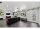Bright living room featuring dark wood floors and updated track lighting and greenery at 2447 Tournament St, Las Vegas, NV 89142