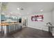 Open concept living and kitchen area with butcher block countertops, stainless steel appliances, and blue cabinets at 2447 Tournament St, Las Vegas, NV 89142