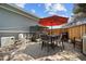 Outdoor patio with comfortable seating, shaded by a large umbrella, perfect for relaxation and gatherings at 2447 Tournament St, Las Vegas, NV 89142