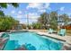 Inviting backyard pool area featuring a pergola, lounge chairs, and lush landscaping at 2447 Tournament St, Las Vegas, NV 89142