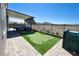Backyard with a synthetic putting green and outdoor kitchen under a covered patio at 2719 Canvas Sky St, Henderson, NV 89044