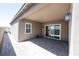 Covered backyard patio with brick pavers, overhead lighting, a window and sliding door at 2719 Canvas Sky St, Henderson, NV 89044