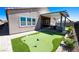 Beautiful backyard featuring a putting green and covered patio with outdoor kitchen at 2719 Canvas Sky St, Henderson, NV 89044