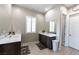 Bright bathroom with double sinks, white countertops, framed mirrors, and tile flooring at 2719 Canvas Sky St, Henderson, NV 89044