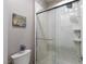 Bathroom featuring a glass-enclosed shower, white tiled walls, and decorative wall art at 2719 Canvas Sky St, Henderson, NV 89044