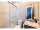 Tiled bathroom with a glass door walk-in shower, toilet, vanity and mirrored cabinet at 2719 Canvas Sky St, Henderson, NV 89044