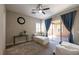 Bedroom with large windows, a ceiling fan, neutral decor, and sliding glass door to the backyard at 2719 Canvas Sky St, Henderson, NV 89044