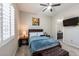 Cozy bedroom with a ceiling fan, window shutters, a bed with throw blanket and carpet at 2719 Canvas Sky St, Henderson, NV 89044