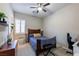 Well-lit bedroom featuring a ceiling fan, a window with shutters, and a wooden bed frame at 2719 Canvas Sky St, Henderson, NV 89044
