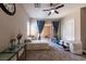 Bedroom with large windows, a ceiling fan, neutral decor, and sliding glass door to the backyard at 2719 Canvas Sky St, Henderson, NV 89044