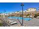 Community pool featuring lounge chairs and lush landscaping for a relaxing experience at 2719 Canvas Sky St, Henderson, NV 89044