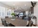 Dining room with a modern chandelier, seating for eight, and an adjacent kitchen area at 2719 Canvas Sky St, Henderson, NV 89044