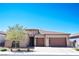 Charming single-story home with a two-car garage, desert landscaping, and a stone accent facade at 2719 Canvas Sky St, Henderson, NV 89044