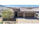 Aerial front exterior view of a desert home with a tile roof and a paved driveway at 2719 Canvas Sky St, Henderson, NV 89044