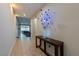 Inviting foyer with a decorative table, sleek lighting, and tile flooring leading to living spaces at 2719 Canvas Sky St, Henderson, NV 89044