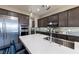 Kitchen area with a stainless steel refrigerator and large island with a stainless steel sink at 2719 Canvas Sky St, Henderson, NV 89044