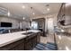 Bright, modern kitchen with stainless steel appliances and an island featuring a large sink at 2719 Canvas Sky St, Henderson, NV 89044