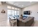 Bright living room with a large sliding glass door, cozy seating, and modern entertainment setup at 2719 Canvas Sky St, Henderson, NV 89044