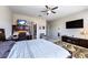 Main bedroom with two televisions, a ceiling fan, and an adjacent bathroom at 2719 Canvas Sky St, Henderson, NV 89044