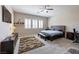 Spacious main bedroom with a ceiling fan, a tv, and three windows with shutters at 2719 Canvas Sky St, Henderson, NV 89044